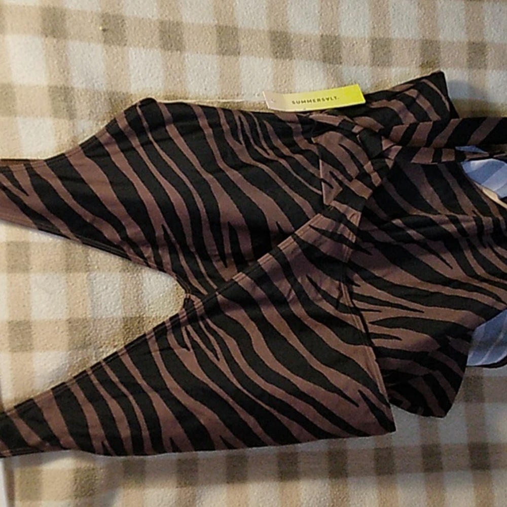 Brand new swimsuit size 12 it has a wrap around that ties on side.